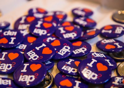 A photo of i heart iap2 badges scattered on a table top